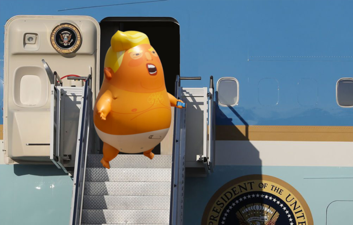 Baby Trump Blimp Descending Air Force One by T.J. Hawk via Flickr (CC BY-SA 2.0)